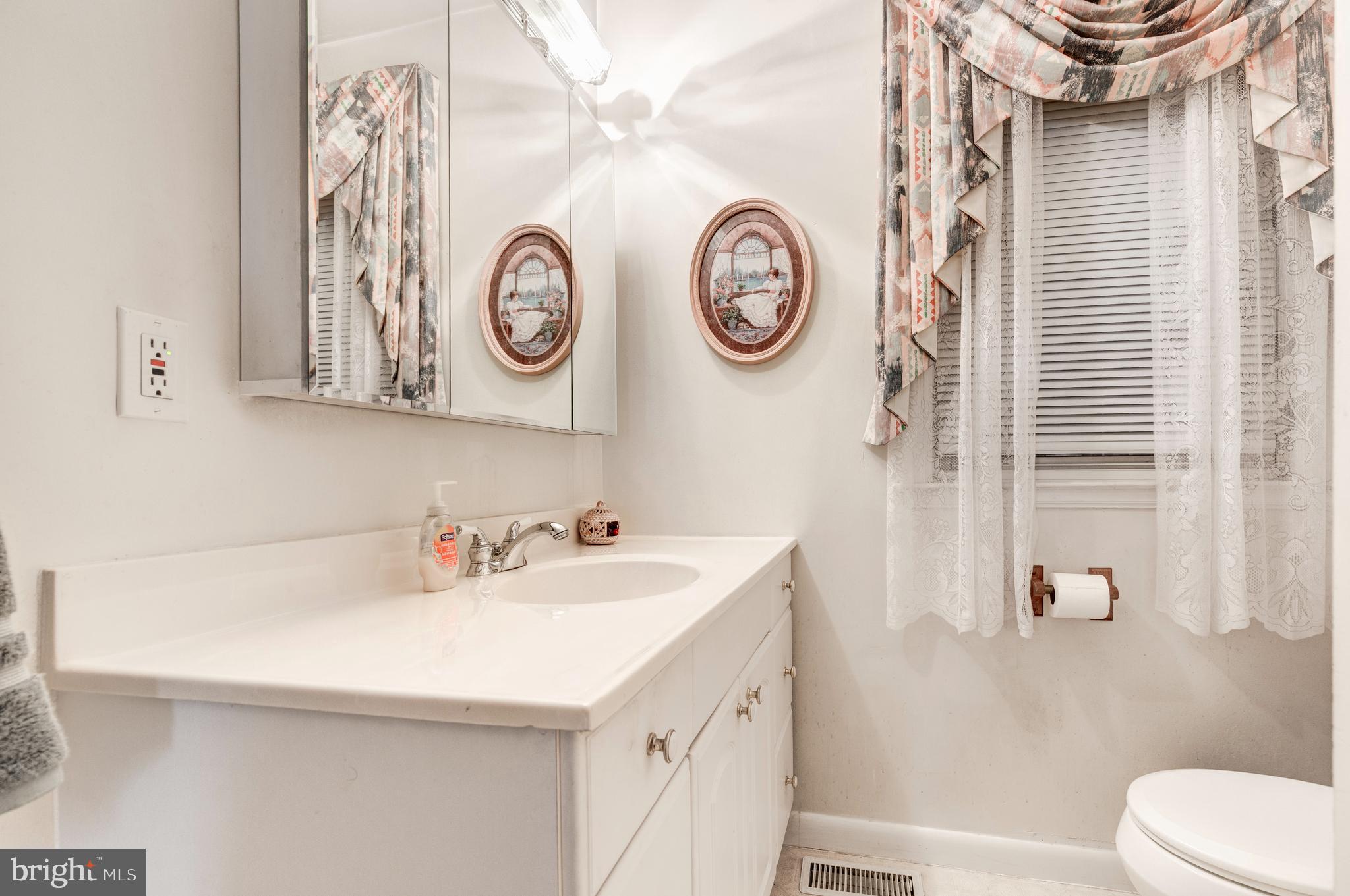 3402 Offutt Road Randallstown, MD 21133 - Photo 37 of 63 a bathroom with a sink and a mirror