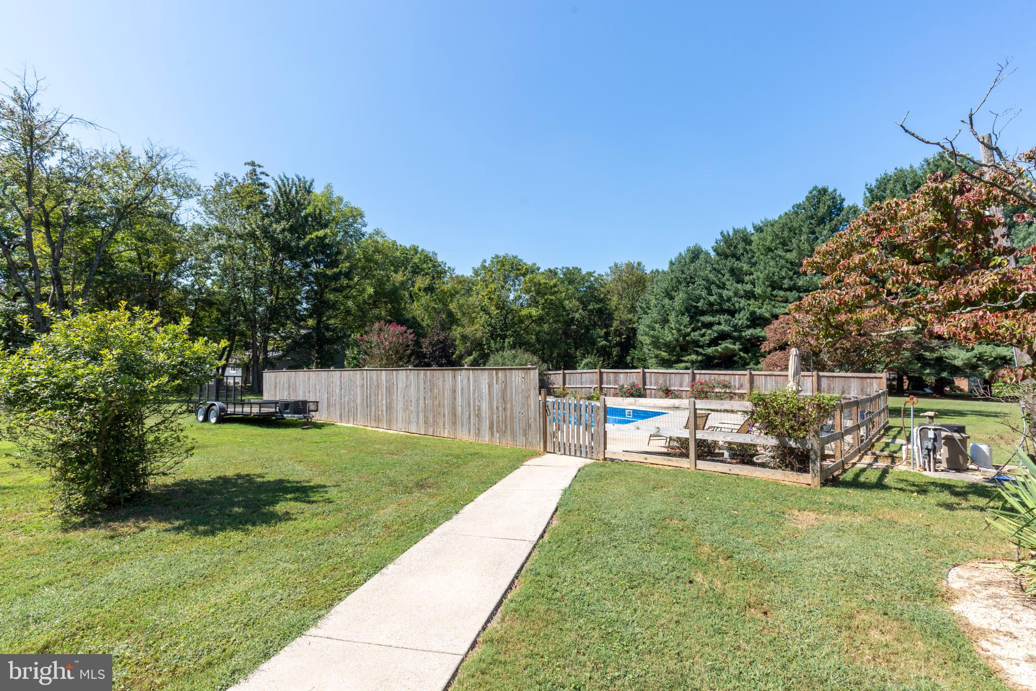 3402 Offutt Road Randallstown, MD 21133 - Photo 52 of 63 Serene backyard oasis with pool and greenery.
