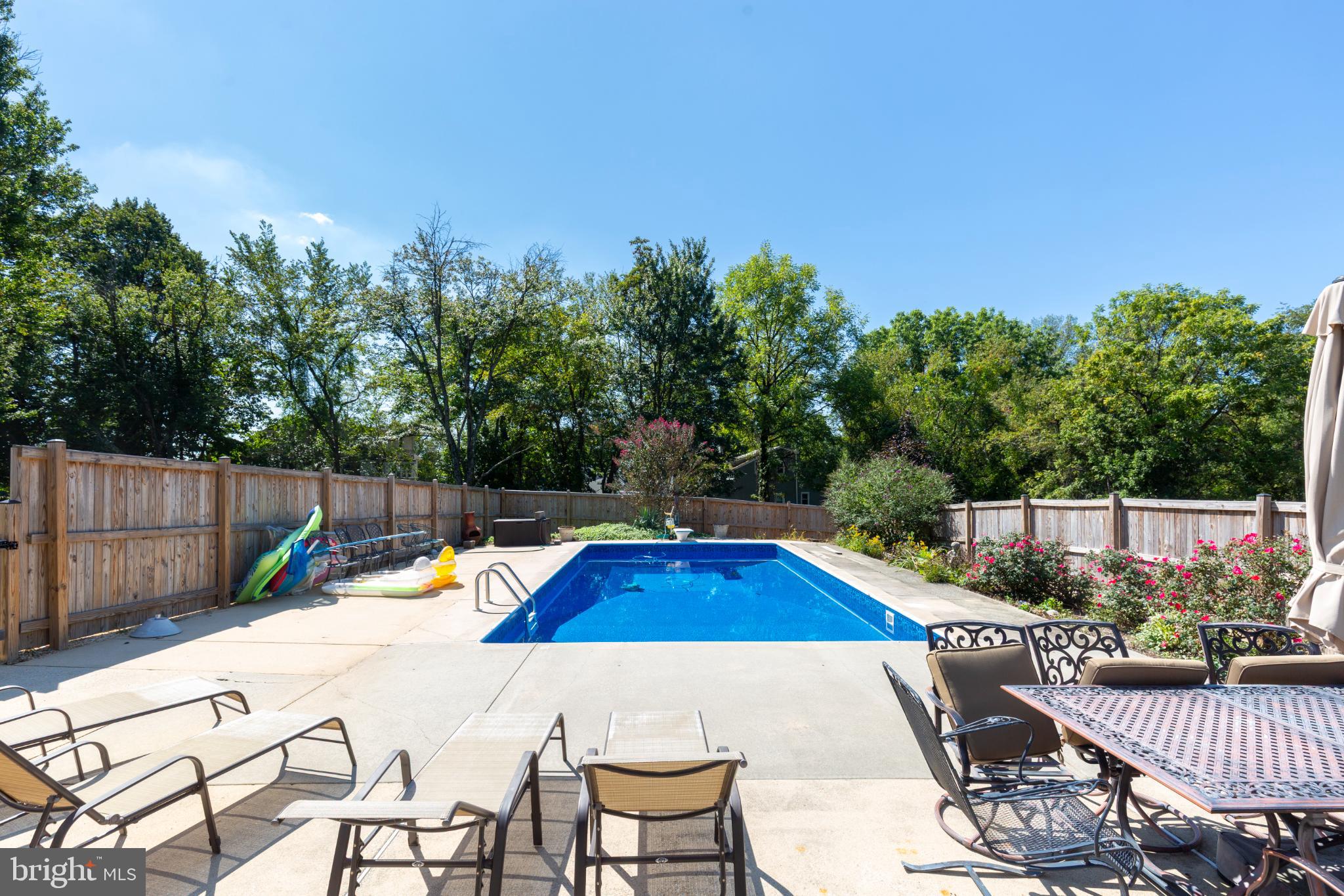 3402 Offutt Road Randallstown, MD 21133 - Photo 54 of 63 a view of a swimming pool with a patio and wooden fence