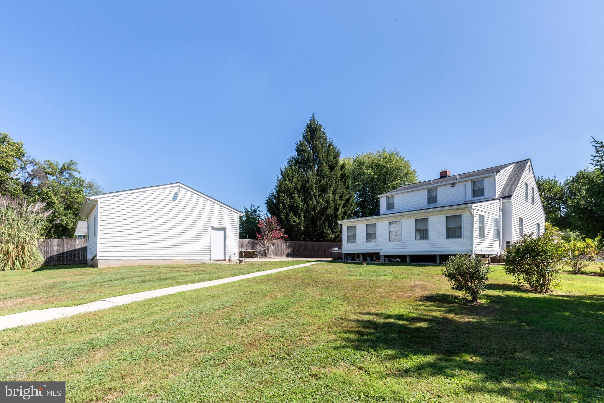 3402 Offutt Road Randallstown, MD 21133 - Photo 59 of 63 a view of a house with a big yard and large trees