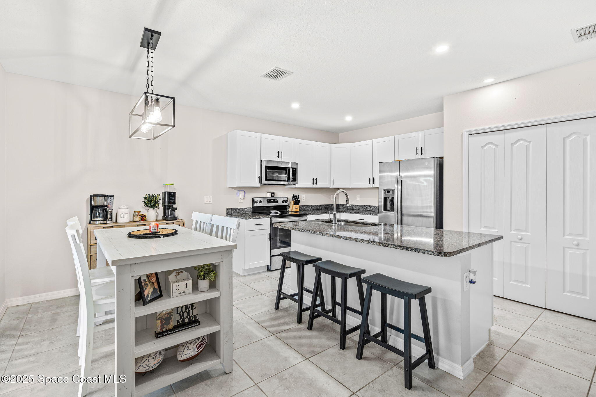 6162 Rena Avenue Cocoa, FL 32927 - Photo 12 of 42 a kitchen with granite countertop cabinets and refrigerator