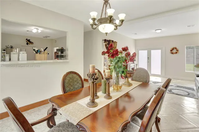 a dining room with furniture and chandelier