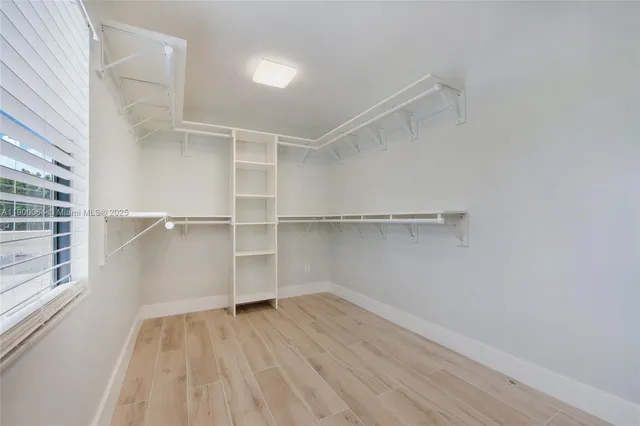 a view of walk in closet with empty racks