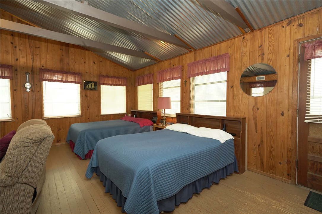 24857 Lakeview (cr 360) Mathis, TX 78368 - Photo 11 of 31 a bedroom with two beds and a large window
