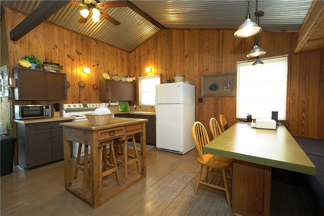 24857 Lakeview (cr 360) Mathis, TX 78368 - Photo 6 of 31 a kitchen with a table chairs and a refrigerator