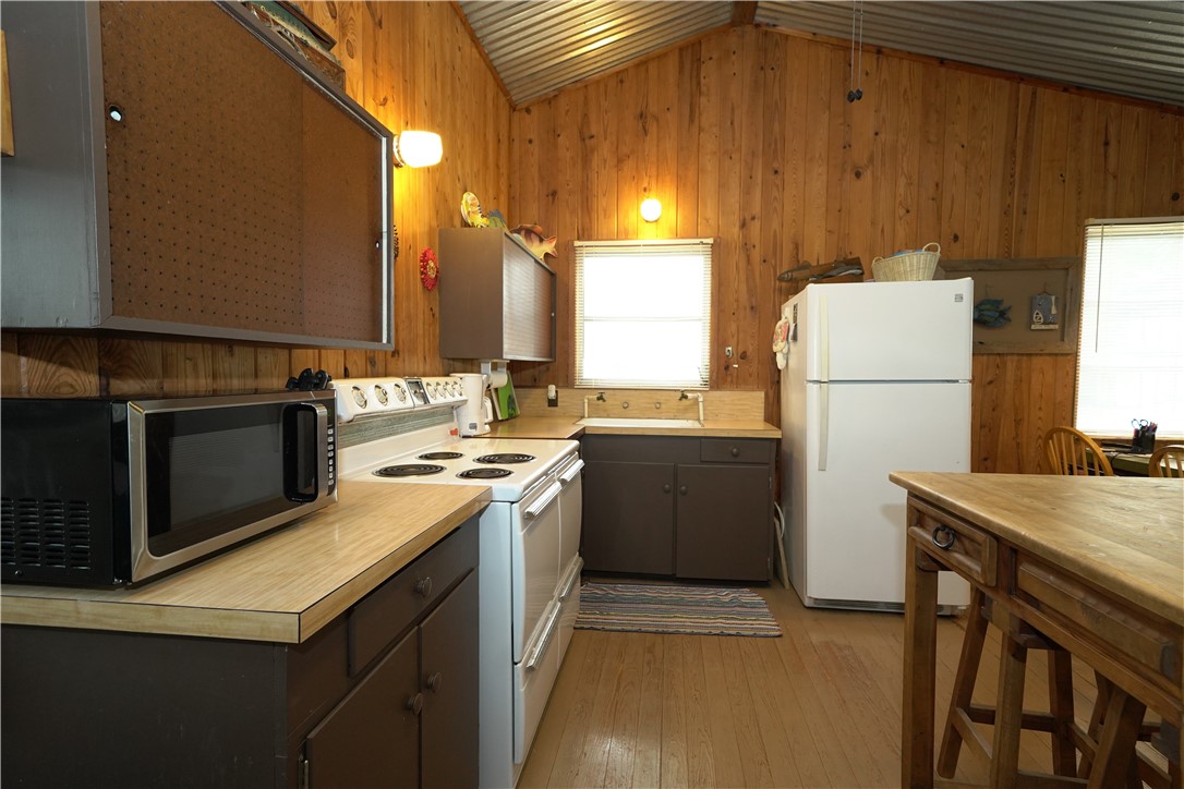 24857 Lakeview (cr 360) Mathis, TX 78368 - Photo 8 of 31 a kitchen with a refrigerator stove and sink