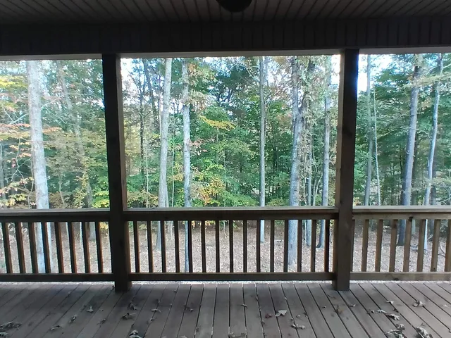 a view of a wooden deck with a yard