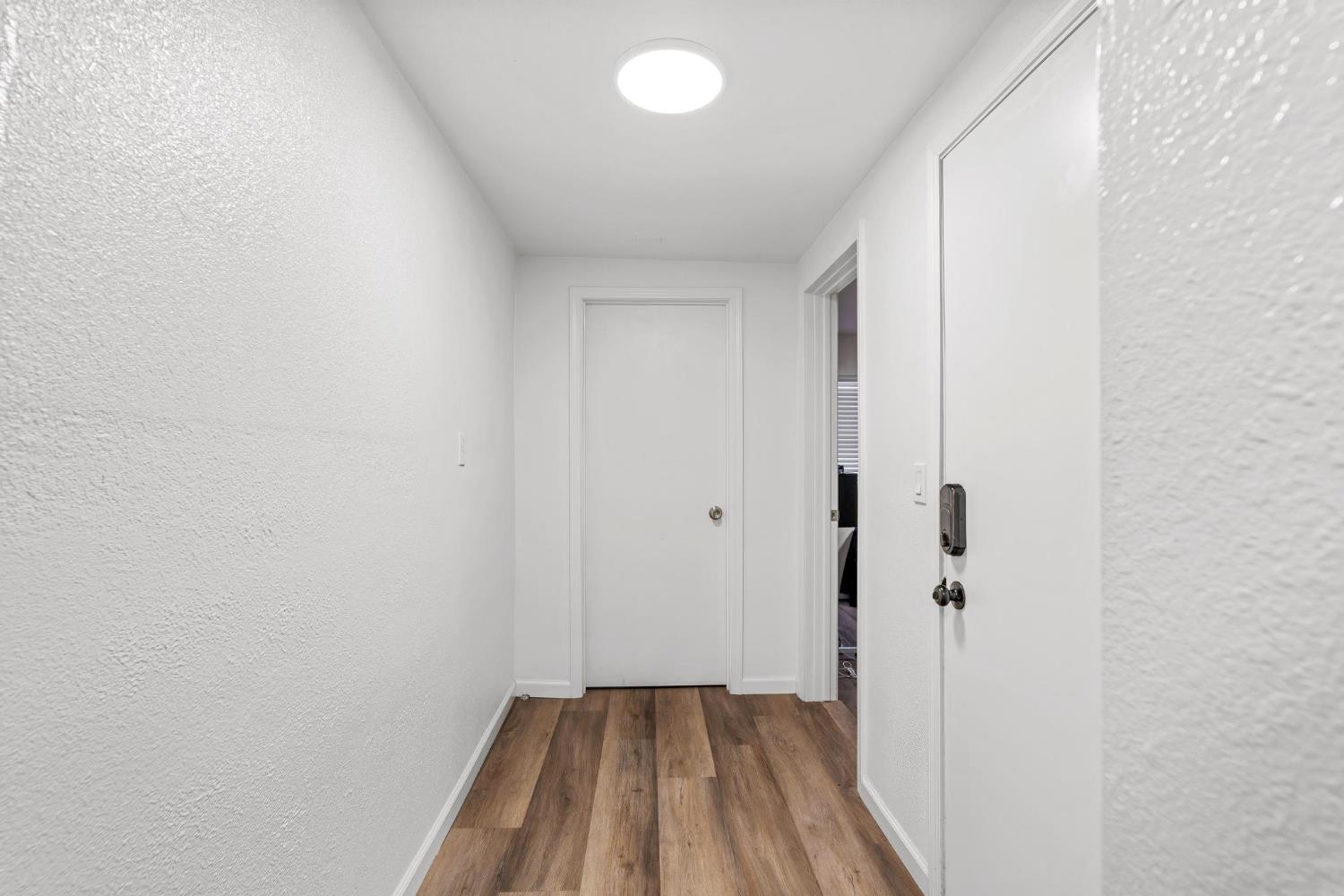 1432 Page Court Modesto, CA 95354 - Photo 14 of 62 a view of a hallway with wooden floor