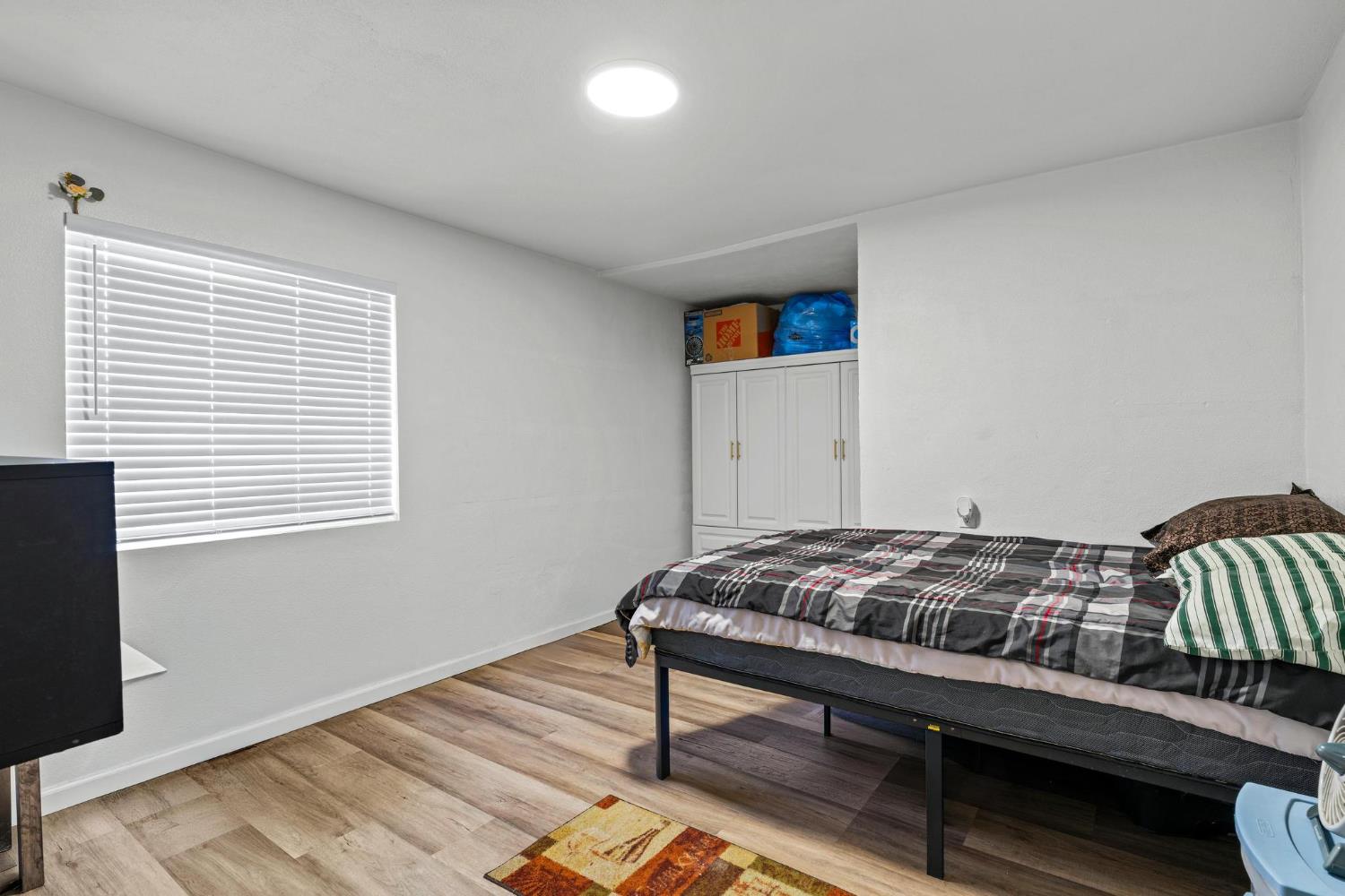 1432 Page Court Modesto, CA 95354 - Photo 20 of 62 a bedroom with a bed and wooden floor