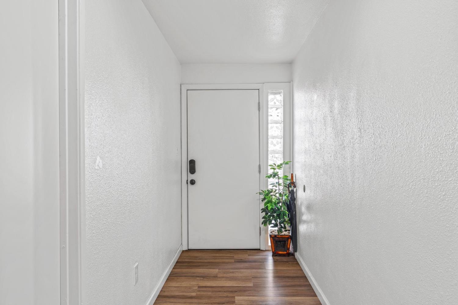 1432 Page Court Modesto, CA 95354 - Photo 5 of 62 a view of a hallway with wooden floor and a staircase