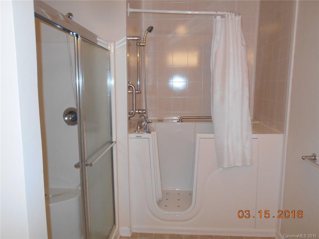 294 Garnet Court, Unit 520 Fort Mill, SC 29708 - Photo 12 of 13 a bathroom with a glass shower door