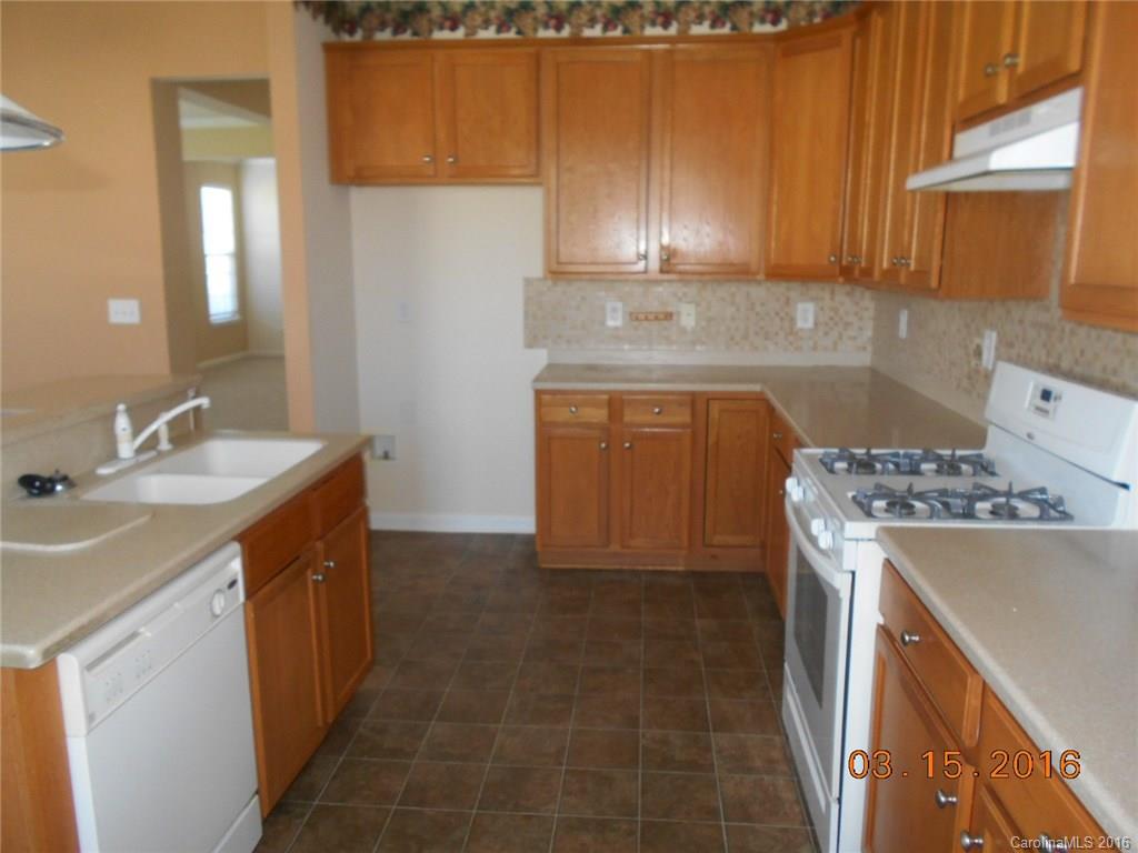 294 Garnet Court, Unit 520 Fort Mill, SC 29708 - Photo 8 of 13 a kitchen with a sink stove and cabinets