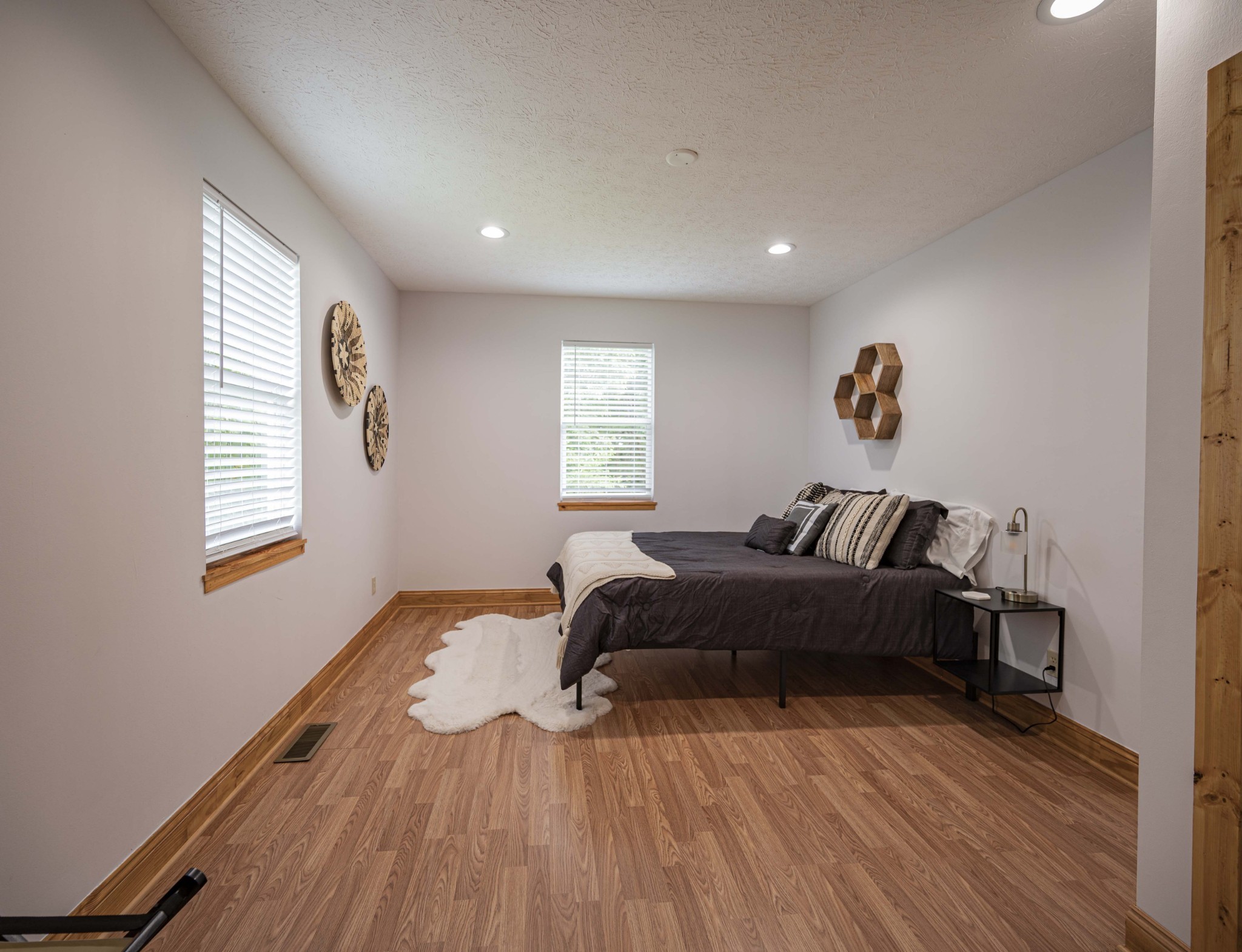2281 Jefferson Road Smithville, TN 37166 - Photo 23 of 25 a spacious bedroom with a bed and wooden floor