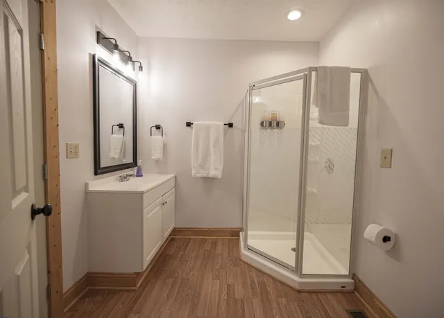 a bathroom with a double vanity sink mirror and shower