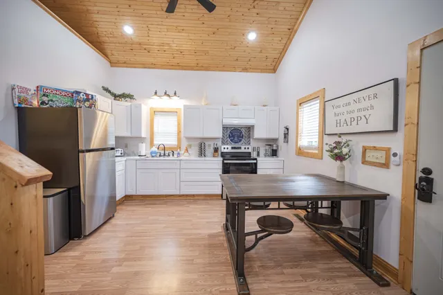 a kitchen with refrigerator cabinets and wooden floor