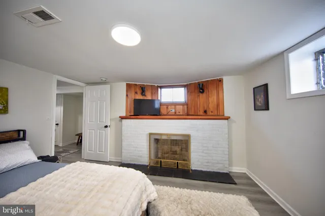 a bedroom with a bed and a fireplace