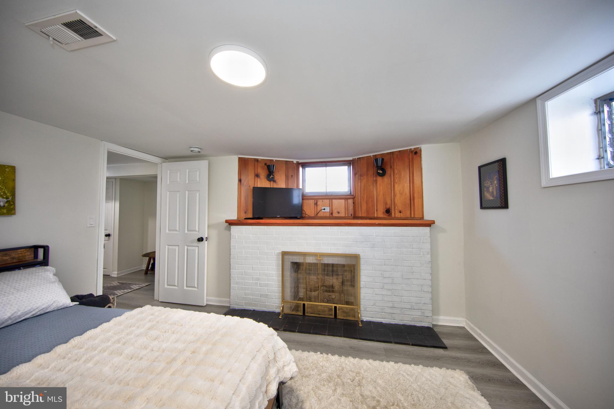 109 Elinor Avenue Nottingham, MD 21236 - Photo 24 of 33 a bedroom with a bed and a fireplace