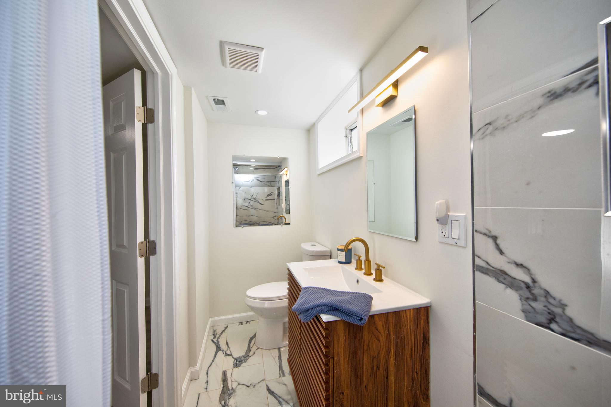 109 Elinor Avenue Nottingham, MD 21236 - Photo 25 of 33 a bathroom with a sink a mirror and a shower