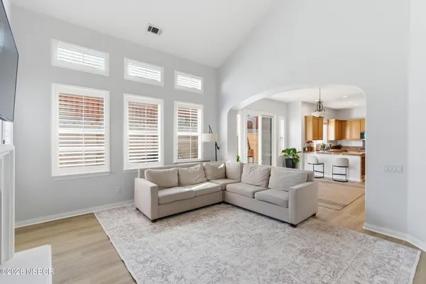 a living room with furniture and a chandelier