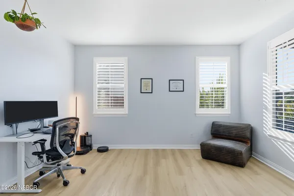 a view of a hallway with wooden floor and closet