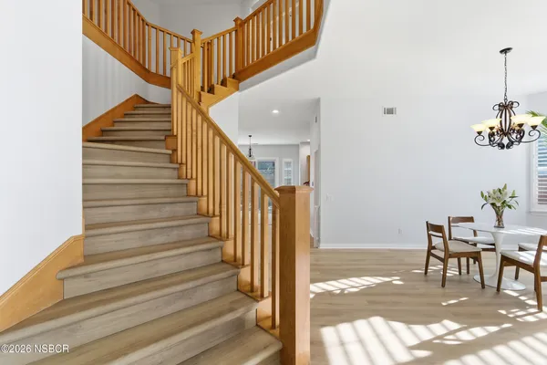 a view of entryway and hall with wooden floor
