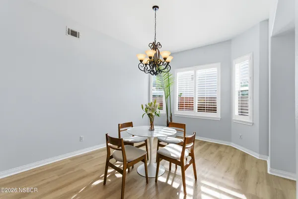 a dining room with furniture and window