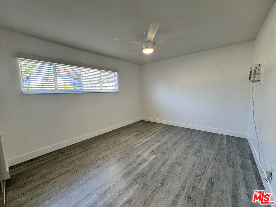1279 North Harper Avenue, Unit 5A West Hollywood, CA 90046 - Photo 11 of 16 an empty room with wooden floor and windows