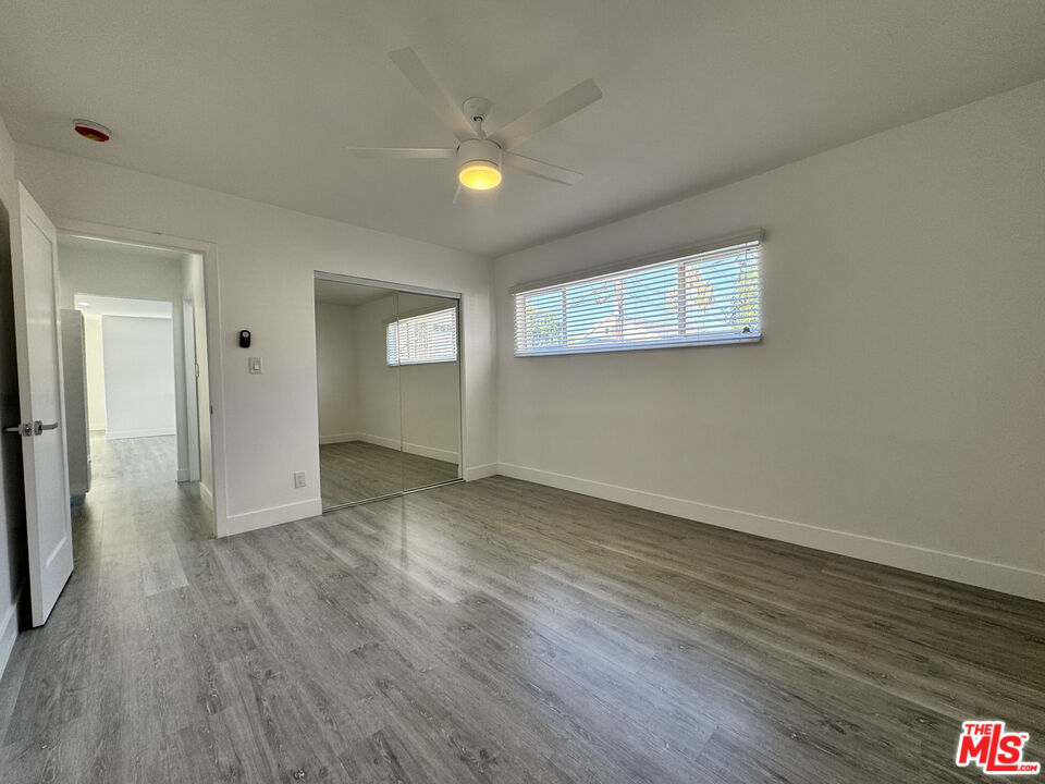 1279 North Harper Avenue, Unit 5A West Hollywood, CA 90046 - Photo 12 of 16 an empty room with wooden floor and windows