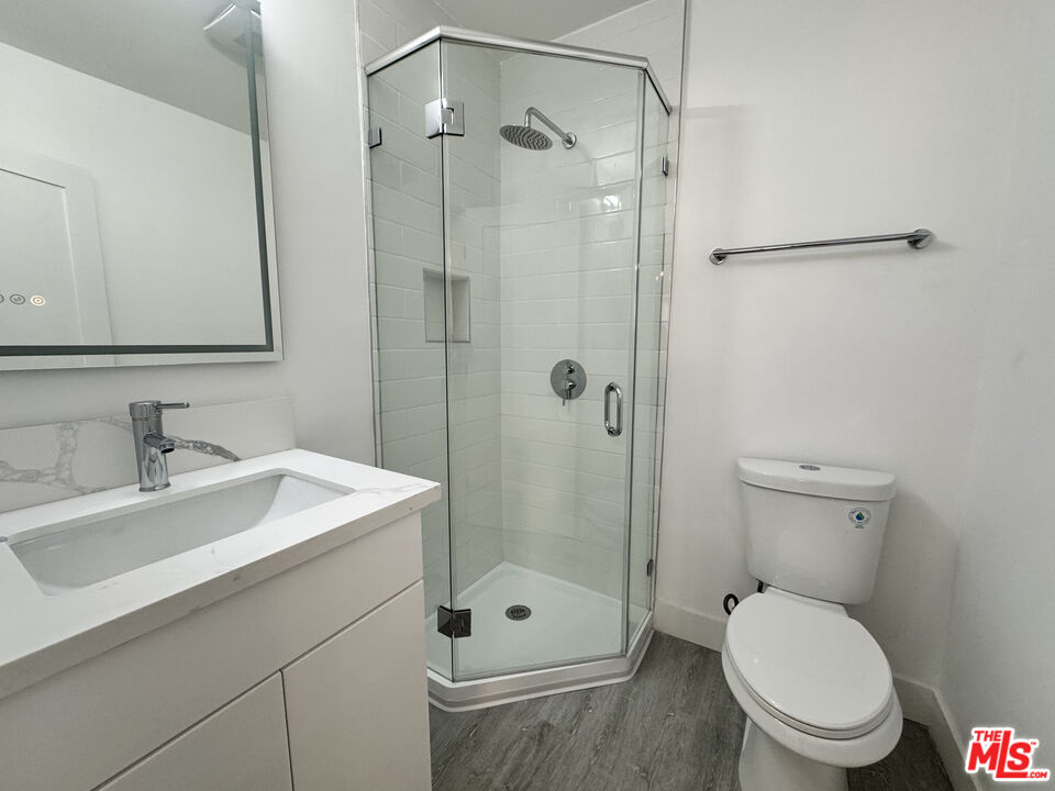 1279 North Harper Avenue, Unit 5A West Hollywood, CA 90046 - Photo 13 of 16 a bathroom with a sink a toilet and shower