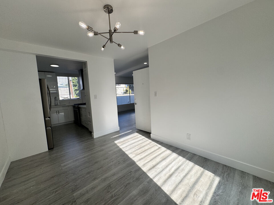1279 North Harper Avenue, Unit 5A West Hollywood, CA 90046 - Photo 8 of 16 wooden floor in an empty room with a window
