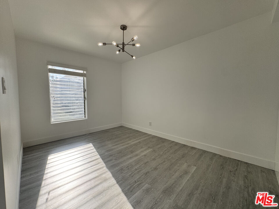 1279 North Harper Avenue, Unit 5A West Hollywood, CA 90046 - Photo 9 of 16 wooden floor in an empty room with a window