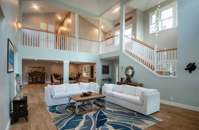 a living room with furniture a rug and a chandelier