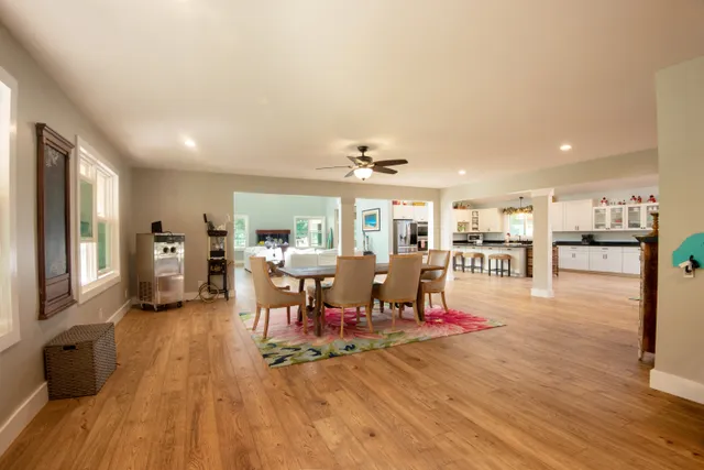 a living room with lots of furniture and kitchen view