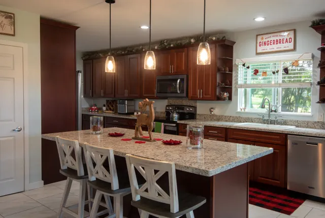 a kitchen with a table chairs and white cabinets