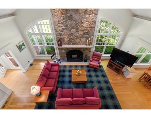 45 Pine Street Weston, MA 02493 - Photo 15 of 27 a living room with furniture a fireplace and a floor to ceiling window