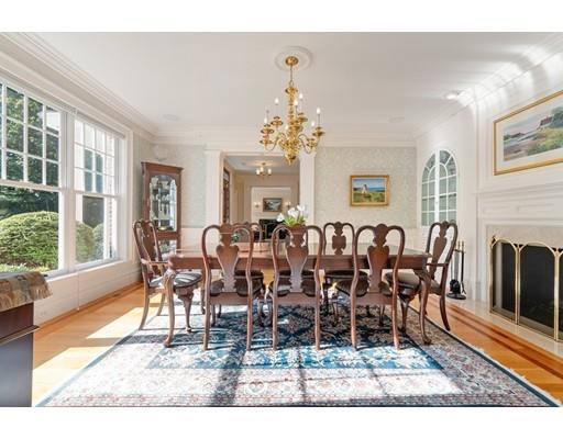 45 Pine Street Weston, MA 02493 - Photo 8 of 27 a dining room with wooden floor a chandelier a wooden table and chairs