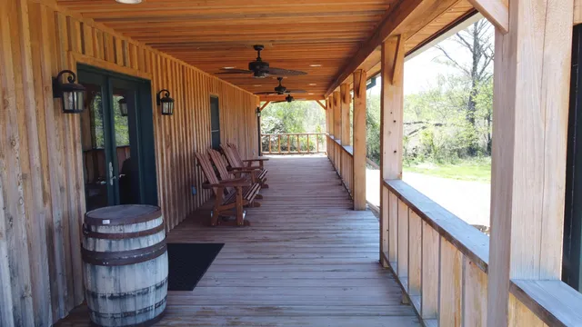 a view of a porch with furniture and a yard