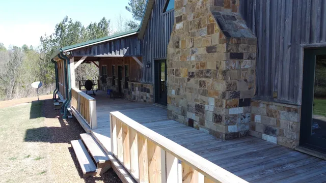 a view of a grassy field with trees in the background