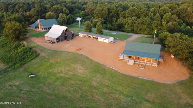 an aerial view of a house with pool yard and outdoor seating