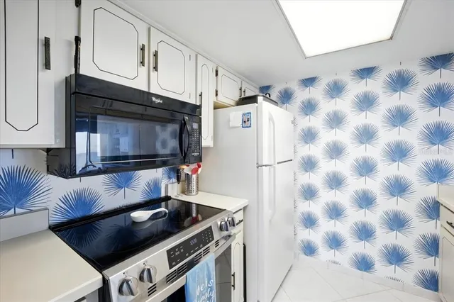a kitchen with a sink and a refrigerator