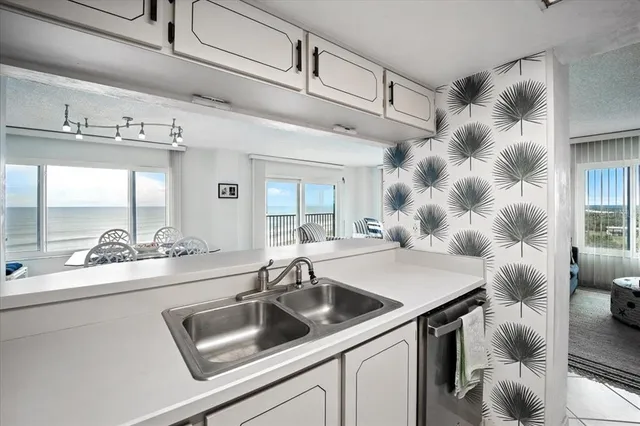 a bedroom with a bed and large window