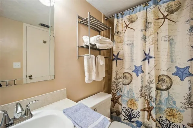 a bedroom with a bed couch and window