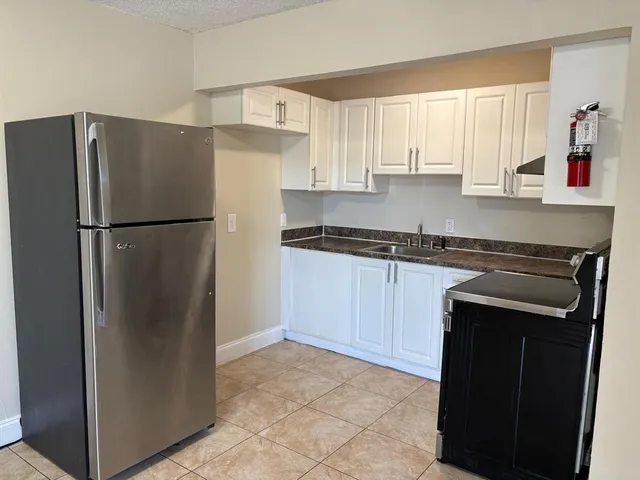 a white refrigerator freezer sitting in a kitchen