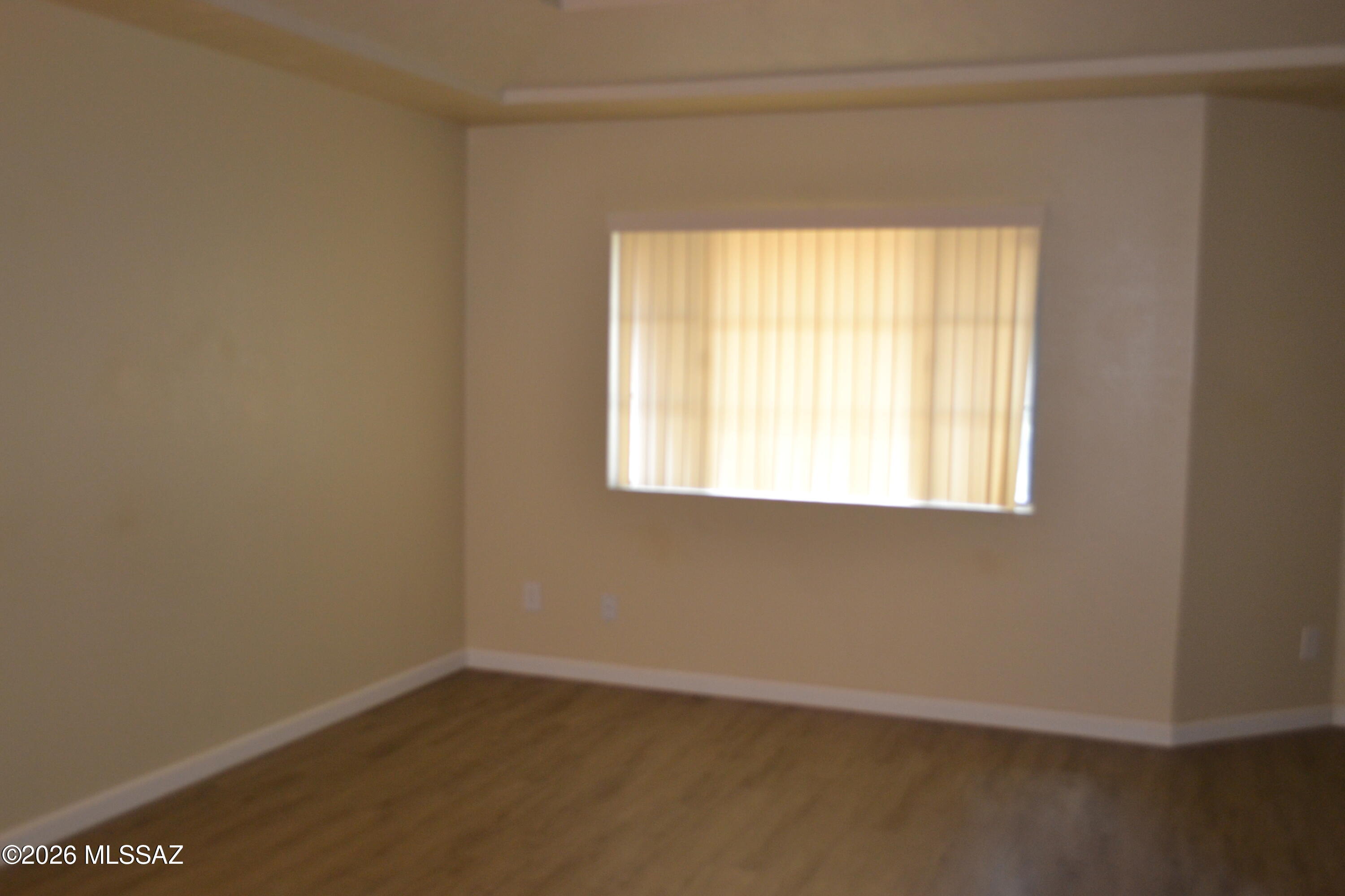 1200 East River Road, Unit D47 Tucson, AZ 85718 - Photo 3 of 13 an empty room with a window