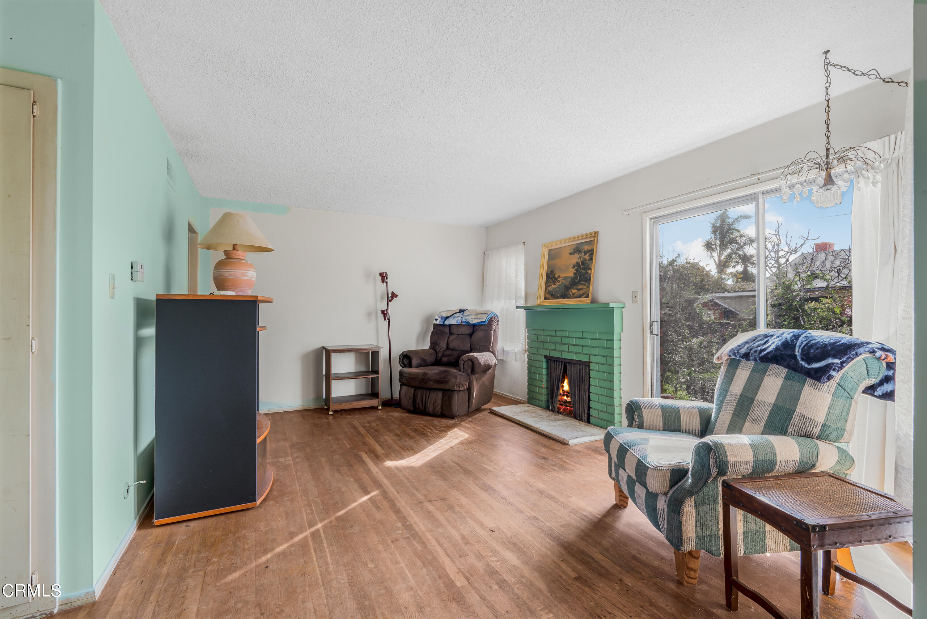 3619 A Court Oxnard, CA 93033 - Photo 4 of 23 a living room with furniture a flat screen tv and a fireplace