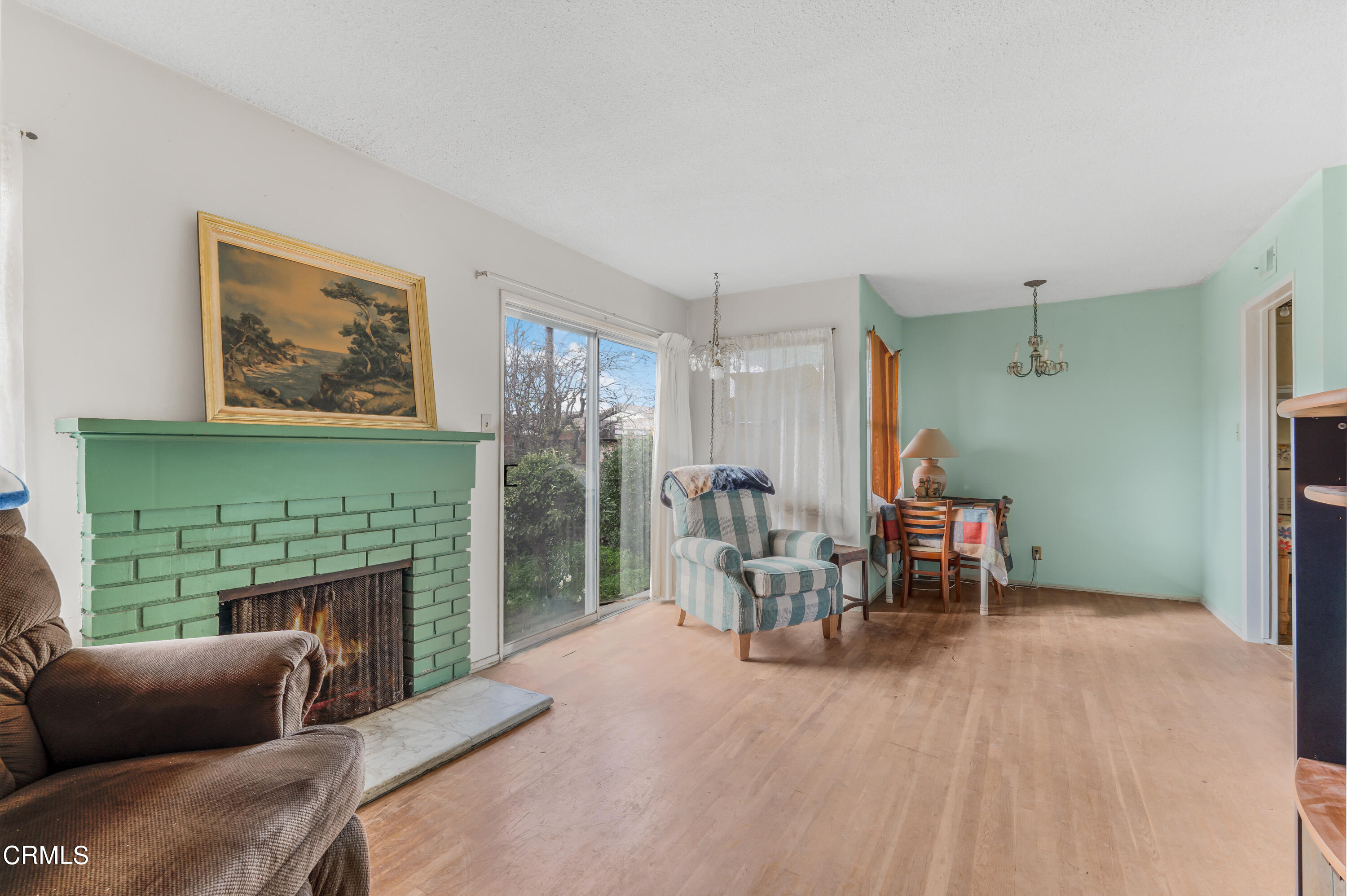 3619 A Court Oxnard, CA 93033 - Photo 5 of 23 a living room with furniture a fireplace and a table