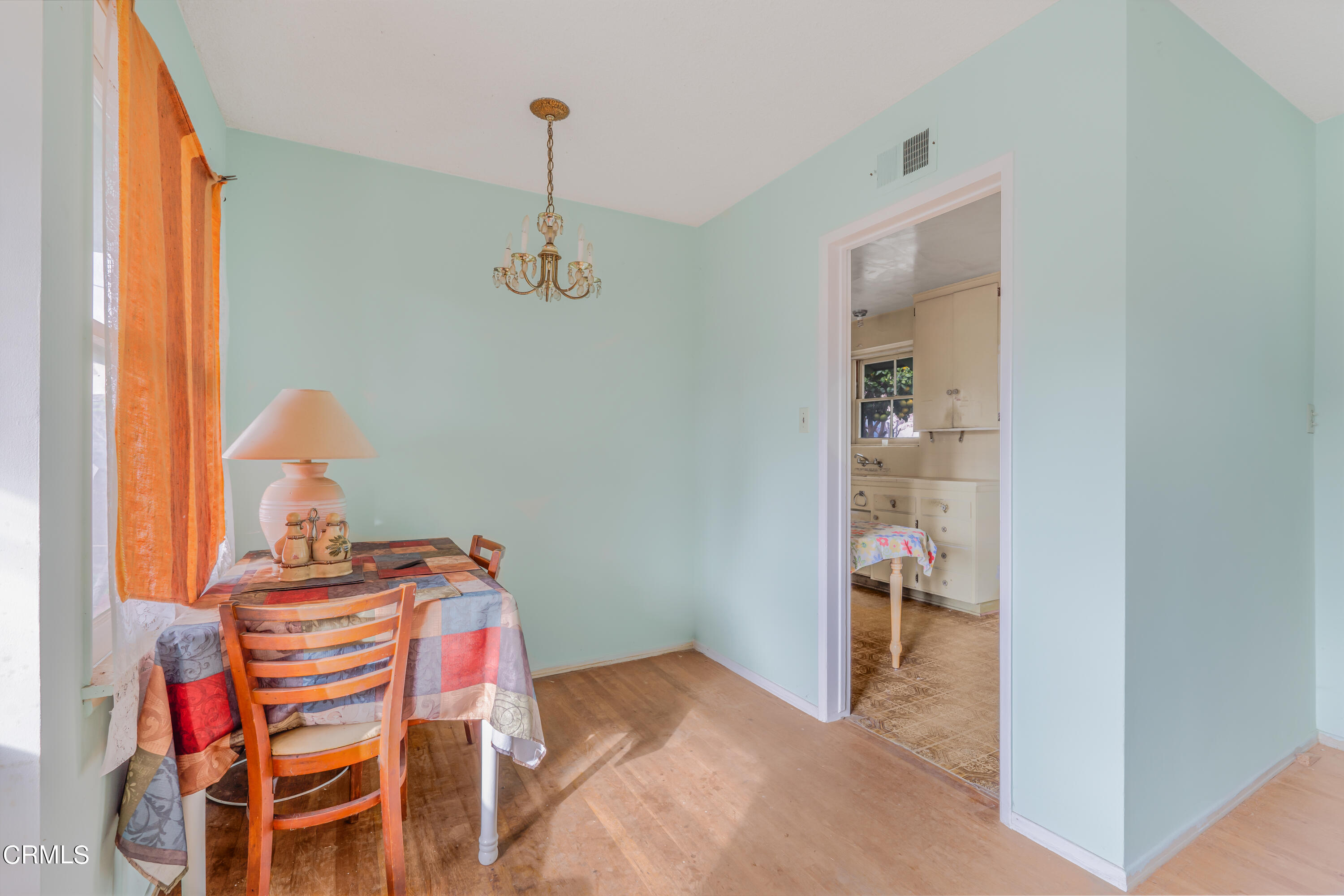 3619 A Court Oxnard, CA 93033 - Photo 6 of 23 a bedroom with a bed and a chandelier