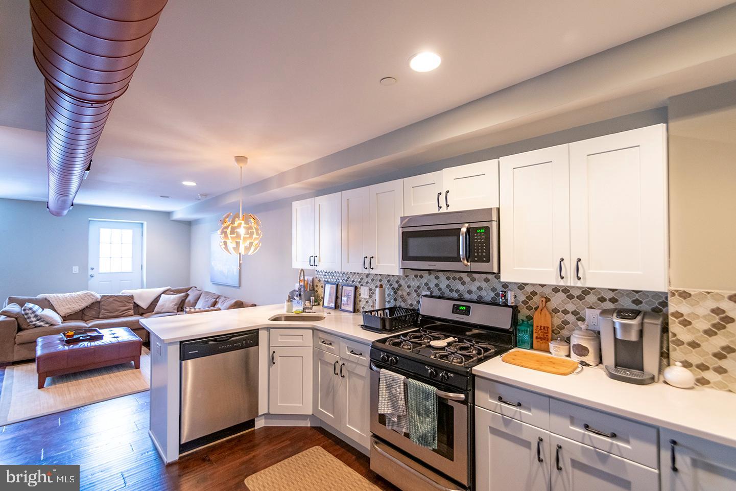 19 North 3rd Street, Unit 4 Philadelphia, PA 19106 - Photo 2 of 10 a kitchen with stainless steel appliances granite countertop a stove a sink and a microwave