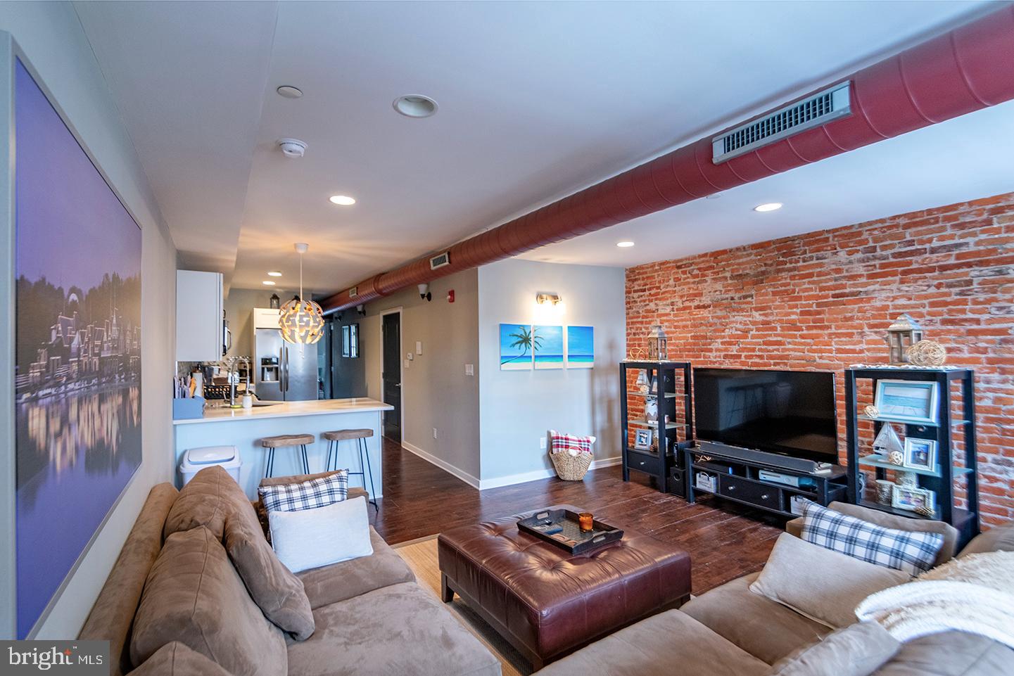 19 North 3rd Street, Unit 4 Philadelphia, PA 19106 - Photo 3 of 10 a living room with furniture and a flat screen tv