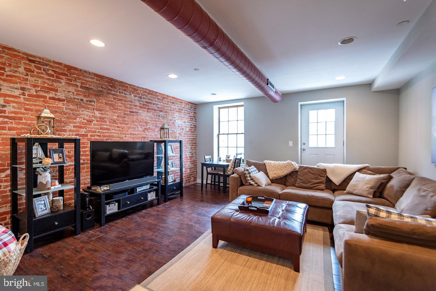 19 North 3rd Street, Unit 4 Philadelphia, PA 19106 - Photo 4 of 10 a living room with furniture and a flat screen tv